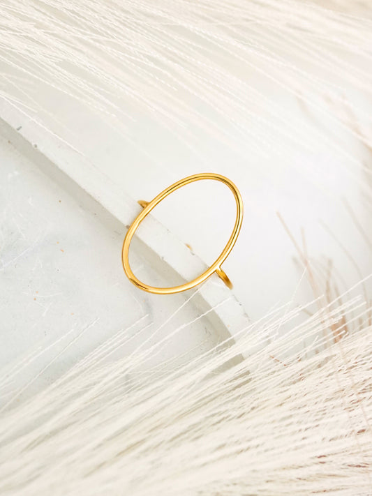 Gold-plated ring on a textured white surface